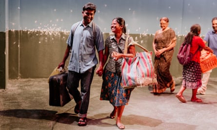 Rajan Velu and Kalieaswari Srinivasan carrying suitcases and bags while blindfolded Anandavalli walks behind them at a distance