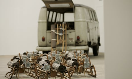 Sledges, resembling a pack of dogs, tumble from the back of a VW van in The Pack, a 1969 work by Joseph Beuys