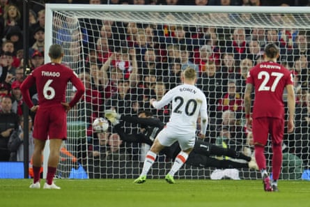 Liverpool's goalkeeper Alisson saves a penalty shot by West Ham's Jarrod Bowen.