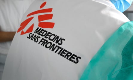 An MSF worker wears clothing with the name of the organisation on the back