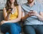 Couple sitting on couch with remote control and smartphone, partial view. After more than a decade in family law, Gabriella Pomare has seen certain catalysts for ‘silent divorce’ – and the strategies that can help