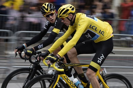 Luke Rowe riding on the Champs-Élysées with Chris Froome in Team Sky kit.