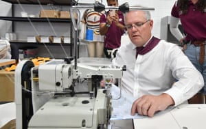 Australian Prime Minister Scott Morrison is seen using a sewing machine during a tour of Struddys sports apparel factory in Brisbane, Monday, May 17, 2021.