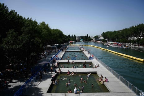 People cool off at floating pools set up on the Ourcq canal in Paris on Thursday.