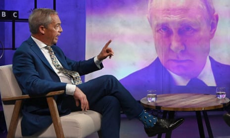 Nigel Farage sitting in BBC studio with picture of Vladimir Putin on the screen