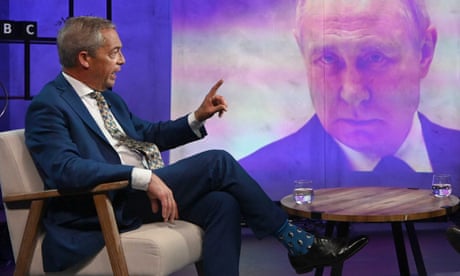 Nigel Farage sitting in BBC studio with picture of Vladimir Putin on the screen