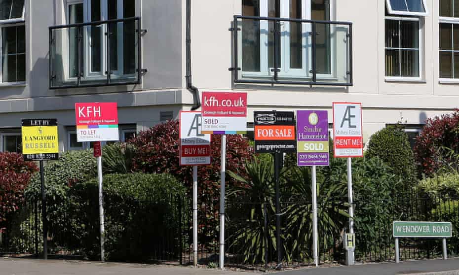 Estate agent signs surround a block of flats in Kent, April 2020.
