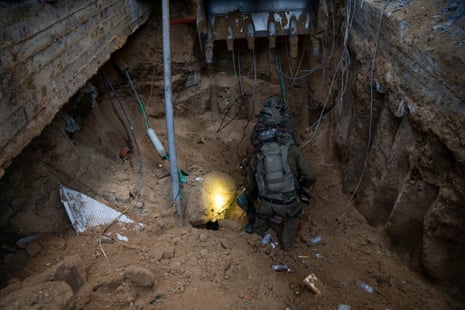 A handout photograph from Israel’s military shows Israeli soldiers taking position at what they say is a tunnel in a location given as Gaza.