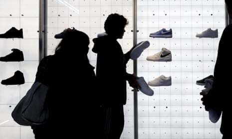 People shop for shoes in a Nike store on 25 November 2022 in New York, New York.