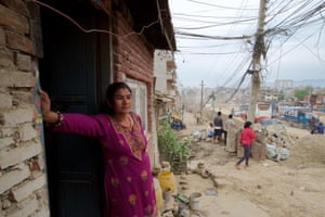 Rambika Thapa Magar stands outside her one room home on the edge of Kathmandu’s ringroad. The expanded road is due to cut through the middle of the house. “We have been told to evacuate. The demolition could started at any time, maybe while we are sleeping. We have nowhere else to go,” said Rambika