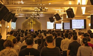 Members of the Early Rain Covenant Church pray during a meeting in their church before it was shut down in December 2018.