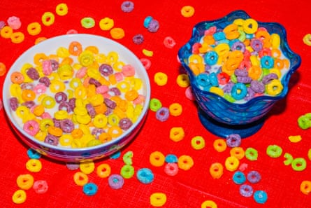 two different bowls of circle-shaped cereal; the one of the left has colors that are more dull than the one on the right
