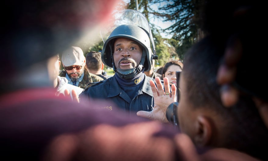 A California officer urges protesters to move off an interstate highway during the Thursday demonstration.