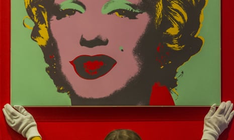 A curator hangs one of 10 screenprints of Marylin Monroe by Andy Warhol.