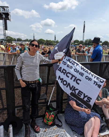 Glastonbury 2023 – follow Friday’s action live! | Glastonbury 2023 13 An Arctic Monkeys fan prepares for the band’s headline set at Glastonbury festival 2023.