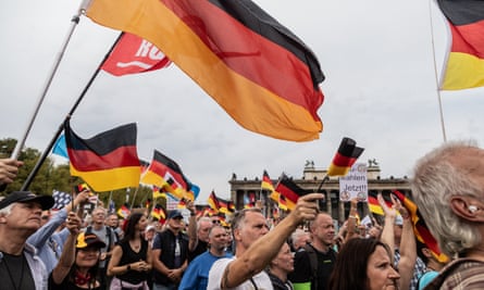 Supports amid German flags at AfD rally last October.