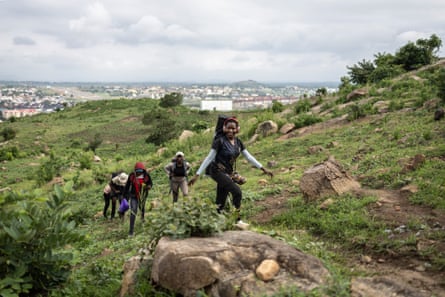 A hiker leads a group along a rocky path