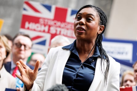 Kemi Badenoch outside Westminster town hal with supporters and a union jack