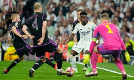 Real Madrid's Vinicius Junior (second right) attempts a cross which is cleared for a corner against Bayern Munich.