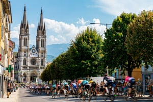 The peloton in action near the Eglise Saint Bruno de Voiron during stage 16 from La Tour-du-Pin to Villard-de-Lans.