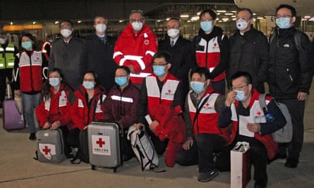Chinese medics posing on 13 March after arriving in Rome from Shanghai to help fight the coronavirus.