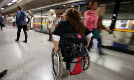 A person in a wheelchair prepares to board the London Underground