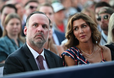 man and woman seated outside in crowd