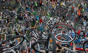 Cyclists in Budapest hold up their bikes