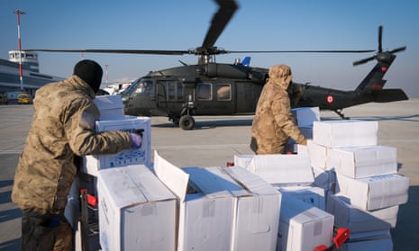 Humanitarian aid dispatches continue as people load packages to a military helicopter at Kahramanmaras Airport.