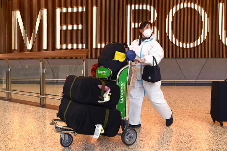 International travellers wearing personal protective equipment arrive at Melbourne’s Tullamarine airport this week