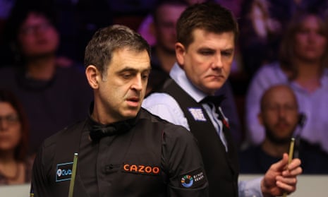 Ronnie O'Sullivan and Ryan Day ponder their next move during their World Snooker Championship last-16 match.