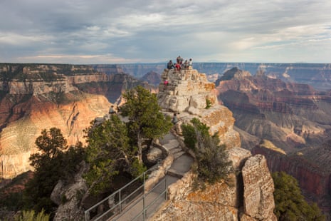 Tourists gathering on a rock outcrop at Bright Angel Point, North Rim, Grand Canyon, Arizona.