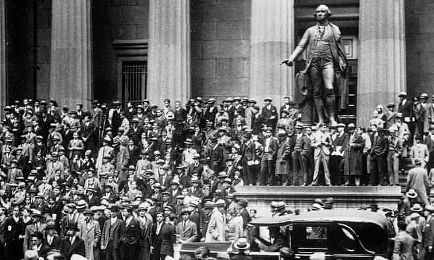 A crowd of speculators gather in front of the New York stock exchange on Black Thursday, 24 October 1929.
