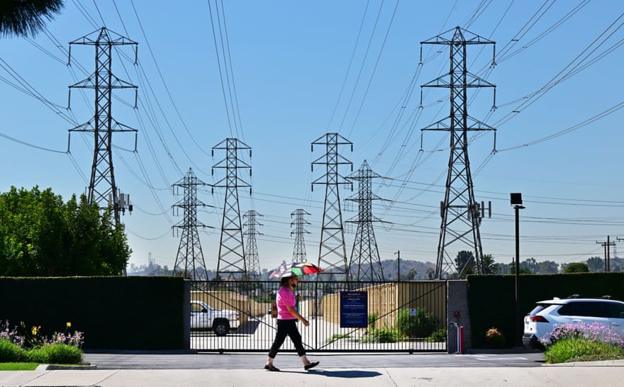 A pedestrian uses an umbrella in the heat in Rosemead, California.