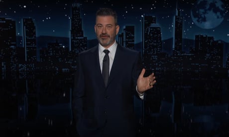 A man in suit gesturing as he talks.