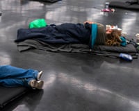 people lie on the ground in a cooling center