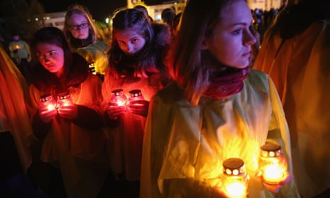Young people prepare to lay candles as part of a ceremony to commemorate the 30th anniversary of the Chernobyl disaster.