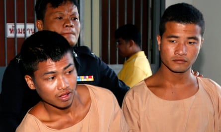 Wai Phyo (left) and Zaw Lin are escorted by a Thai police officer after being sentenced to death.
