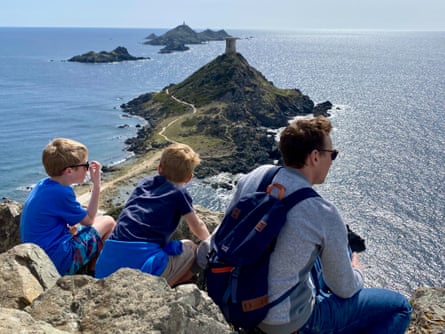 The writer's family overlooking the sea from Pointe de la Parata.