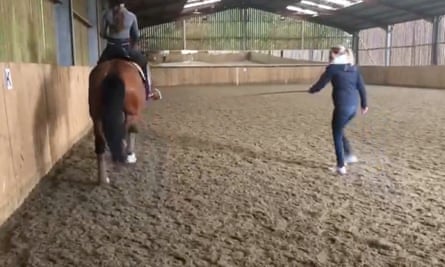 A still from a video showing Charlotte Dujardin whipping a horse repeatedly during a coaching session