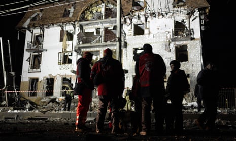 Ukrainian rescue personnel work at the site of a Russian missile attack