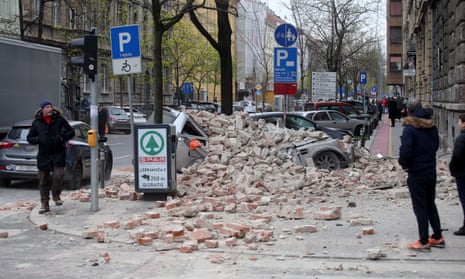 A car is buried under rubble after the earthquake in central Zagreb