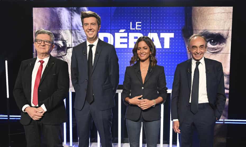 Jean-Luc Mélenchon, left, and Éric Zemmour, right, pose with the French journalists and hosts Maxime Switek and Aurélie Casse prior to the debate in Paris.
