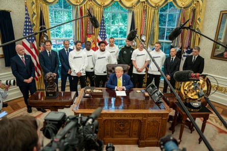 FIFA president Giani Infantino (L) and Juventus coach Igor Tudor (C-Back), with Juventus players attend a meeting with US President Donald Trump (C-Front) in the Oval Office of the White House in Washington, DC
