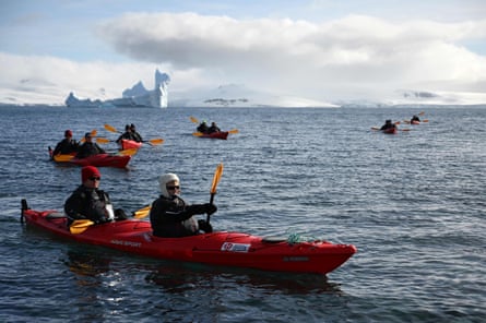 Tourists travel by kayak on Half Moon Island, Antarctica.