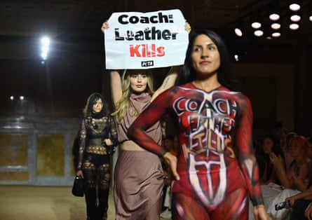 A Peta protester holding a sign reading ‘Coach: Leather Kills’, and another in only underwear and body paint depicting muscles and flesh, on the runway during the Coach spring 2024 show at New York fashion week this month.
