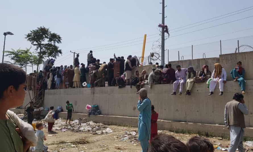 People who want to flee the country continue to wait around Hamid Karzai International Airport in Kabul