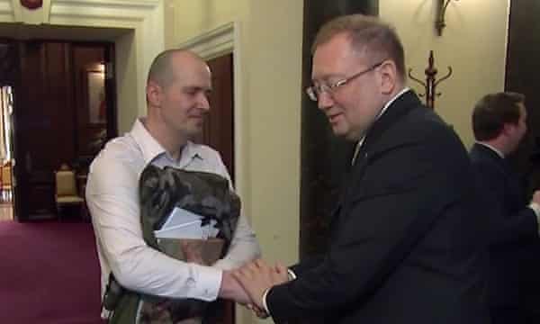 Charlie Rowley shakes hands with Alexander Yakovenko