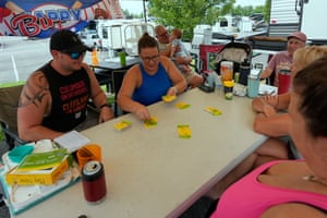 Brandyn Payton, left, and his wife Kelsey Payton, second from left, play a game of cards at their campsite at Bristol Motor Speedway on Friday in Bristol, Tennessee.