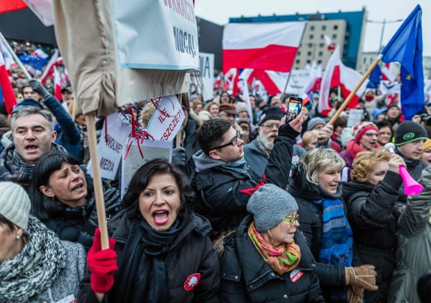 People attend a protest against a new media law in the centre of Warsaw on 9 January 2016
